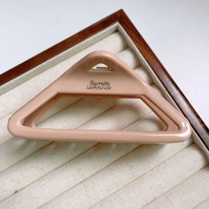 Detail of macaron pink triangle hair claw clip with Barrette La France gold engraving