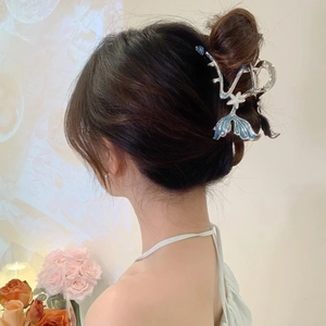 Elegant silver metal fishtail hair claw clip with blue gradient and pearls on model hair