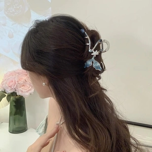 Elegant silver metal hair claw with blue fishtail design for half-tied hairstyles