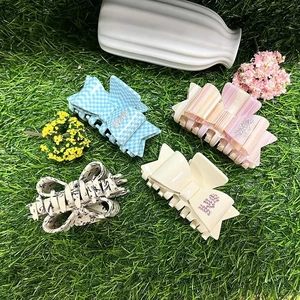 Acetate bow hair claws with rhinestones in checkered and striped patterns