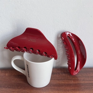 Set of two bright red large hair claws in triangular and crescent shapes for elegant styling
