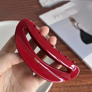Deep burgundy acetate hair claw clip with golden logo showing France handmade detail