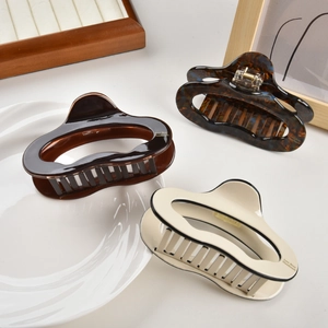 Three-piece large acetate wavy hair claws in tortoiseshell, chocolate, and cream colors