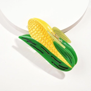 Macro view of corn-shaped acetate hair claw with bright yellow kernels and green leaves
