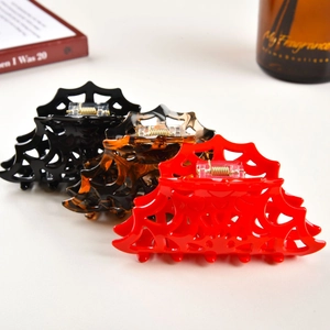 Spider web cutout hair claws set in black, red, and tortoiseshell for Halloween styling