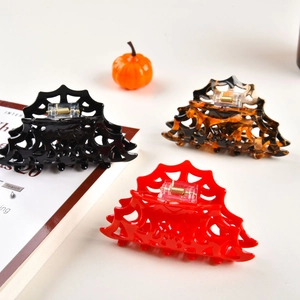 Three-piece Halloween spider web hair claws in black, amber, and red colors