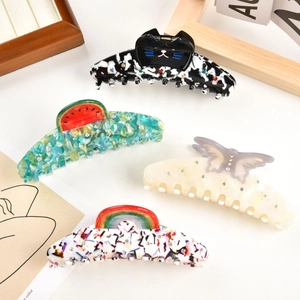 Dettaglio di fermagli per capelli in acetato con farfalle, gatti, arcobaleni e strass