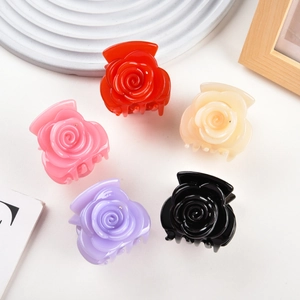 Detailed set of five rose-shaped hair claws in assorted jelly colors on a clean display