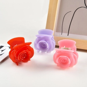 Elegant rose flower hair claws in red, lilac, and pink acetate with secure metal spring