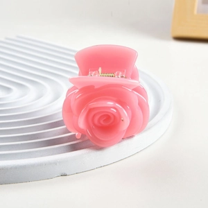 Detailed macro view of the pink rose hair claw clip showing translucent resin texture