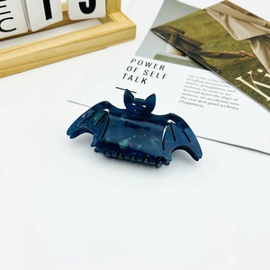 Close-up of dark blue marble texture bat hair claw clip for Halloween gothic styling