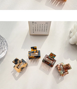 Set of four small acetate square hair claws with stylish tortoise and marble patterns