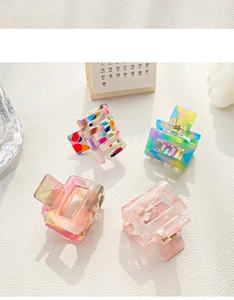 Detail showing four square acetate hair claws in various marble and gradient patterns