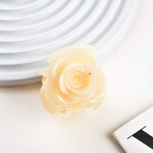 Close-up of cream white rose hair claw clip with glossy resin petals for elegant styling