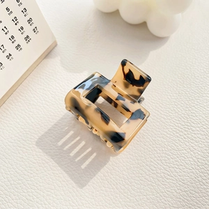 Detail of tortoise shell acetate claw clip with rectangular hollow design and smooth finish