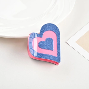 Detailed close-up showing the layered blue and pink denim heart acetate hair claw clip