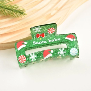 Détail de la pince à cheveux verte à paillettes avec texte Santa Baby et motifs de Noël