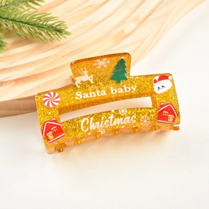 Détail d'une pince à cheveux de Noël avec paillettes dorées et motifs festifs Santa