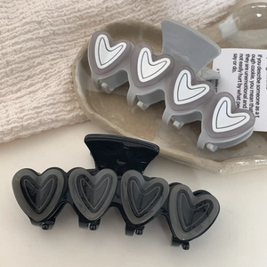 Pinze per capelli a cuore in acetato nei toni grigio e nero per acconciature donna