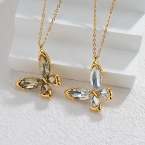 Elegant gold butterfly pendant necklace set with clear and champagne zircon crystals