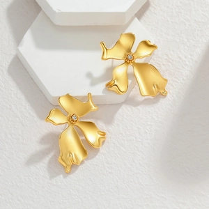 Vintage style gold flower earrings with diamond center petals and a matte finish