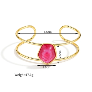 Detail showing dimensions of gold open cuff with pink gemstone inlay and hollow frame