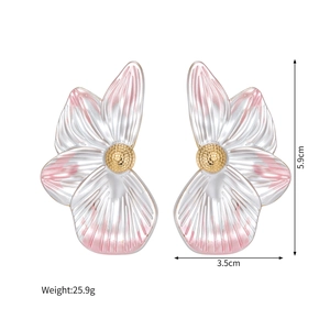 Macro shot of 5.9cm pink and white gradient petal earrings with gold metallic edges