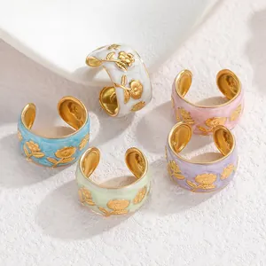 Detail of colorful hand-painted sunflower open rings in various pastel enamel colors