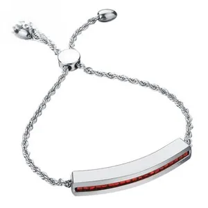 Detail of silver bolo bracelet featuring a curved bar with red crystals and rope chain