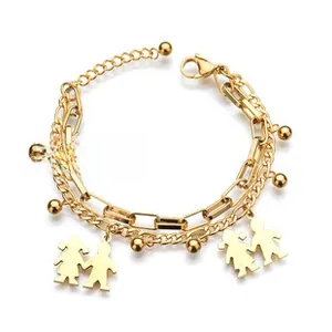 Close-up of gold double-layered bracelet with boy and girl pendants and metal beads