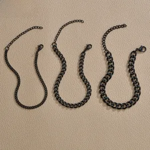 Detailed set of three matte black stainless steel Cuban link chains with lobster clasps