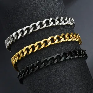 Detailed macro view of Cuban link bracelets in silver gold and black finishes on a stand