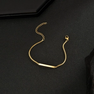 Close-up of polished gold-plated curved bar bracelet with lobster clasp and extender