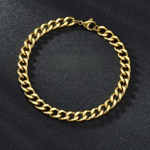 Close-up of golden stainless steel Cuban link bracelet with lobster clasp on black background