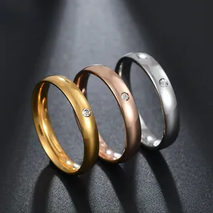 Detail view of 4mm polished dome rings in gold, rose gold and silver with small diamond