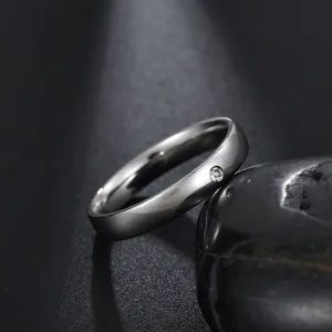 Macro view of 4mm polished ring featuring a single central round-cut cubic zirconia stone