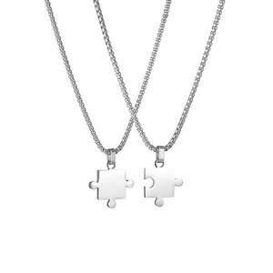 Pair of stainless steel puzzle piece necklaces with polished finish and square links