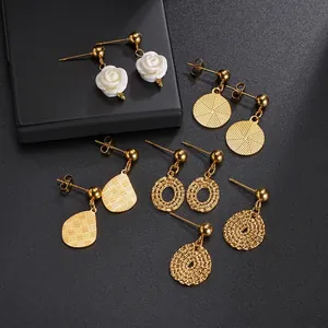 Elegant set of 14K gold plated earrings with floral and geometric patterns on black background