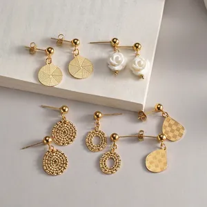 Set of five 14K gold minimalist earrings featuring 3D floral designs and textured geometry