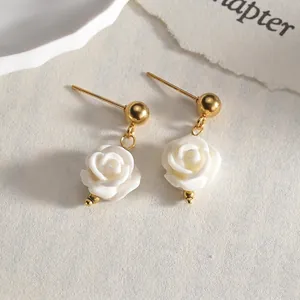 Elegant 14K gold-plated stud earrings with delicate white 3D resin flower pendants