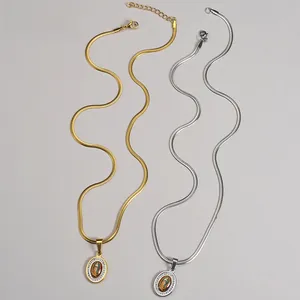 Close-up of Virgin Mary oval pendant on gold and silver stainless steel snake chains