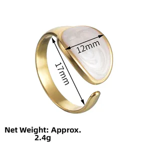 Detail view of gold adjustable ring with white marble texture enamel and 12mm width surface