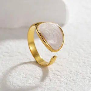 Minimalist gold adjustable open ring featuring an oval white inlay with spiral texture