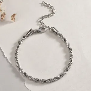 Detailed macro view of silver stainless steel rope chain bracelet with lobster clasp