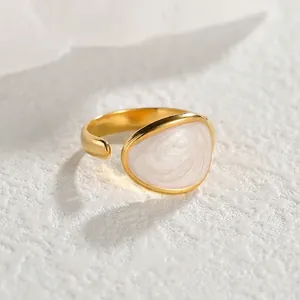 Adjustable gold stainless steel open ring with white enamel inlay and swirl texture