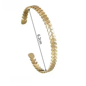 Detail showing gold leaf pattern titanium steel open cuff with 6.2cm inner diameter