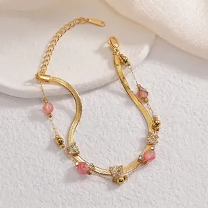 Double-layered gold bracelet featuring pink beads and sparkling butterfly charms