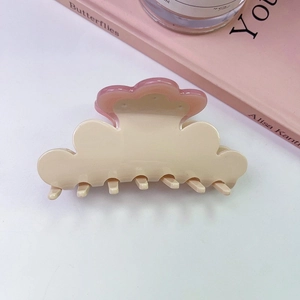 Close-up of pink flower acetate hair claw clip with cloud shape and rhinestone detail