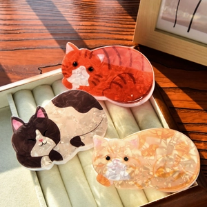 Cute cat-shaped acetate hair claws in various patterns for stylish women's hair styling