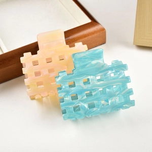 Square hollow hair claws in marbled sky blue and coral pink acetate for women